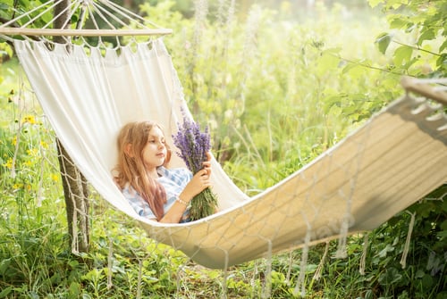 Preview: Young Girl Relaxing in Hammock with Lavender