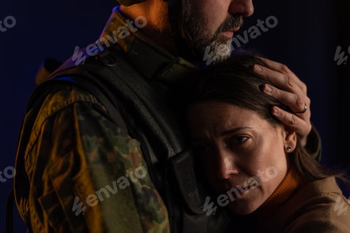 Preview: Close-up of sad woman crying when hugging her military husband and saying-goodby to him