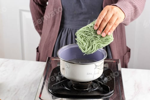 Preview: Female Hand Boiling Lemonilo Healthy Green Indonesian Instant Noodle