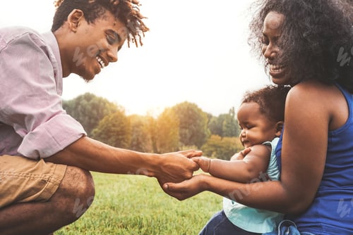 Preview: Happy African family enjoying time together in public park