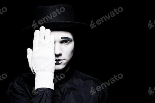 Preview: mime covering eye and looking at camera isolated on black