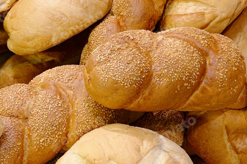 Preview: Golden Brown Loaves of Freshly Baked Bread with Sesame Seeds
