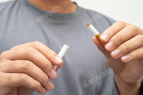 Preview: Quit smoking, Asian teenage man breaking destroy cigarette in hand.