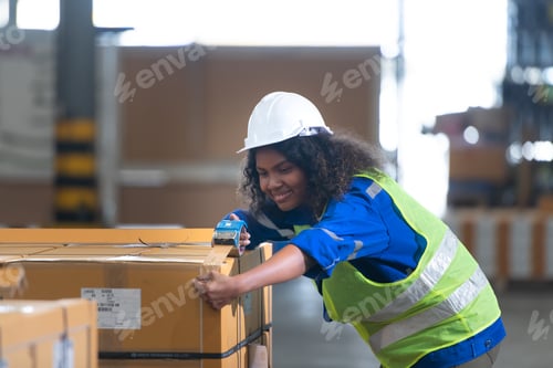 Preview: Worker in auto parts warehouse Packing small parts in boxes