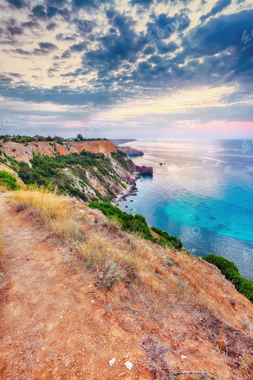 Preview: Mesmerizing sunset at cape Fiolent with bushes grass and rocks at foreground