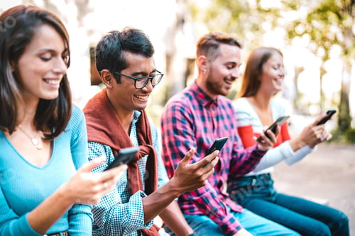 Preview: Multicultural students laughing using smartphone at university college campus