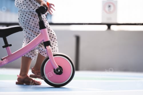 Preview: Close-up of a Child with balance bike with copy space. Learning to ride a bike concept.