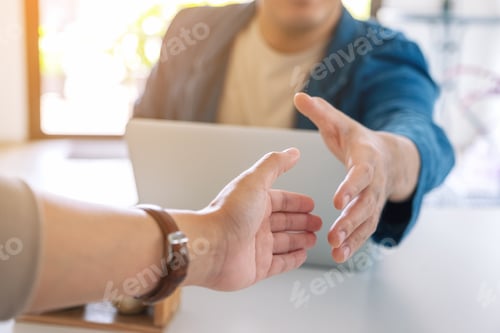 Preview: Two businessman open hand to shaking hands