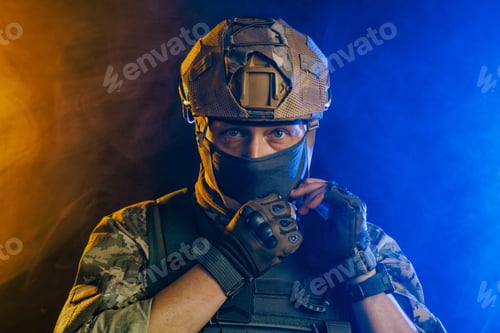 Preview: Portrait of a Ukrainian tactical soldier in combat gear on a bright orange and blue background