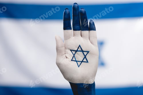 Preview: cropped view of female hand with star of david near flag