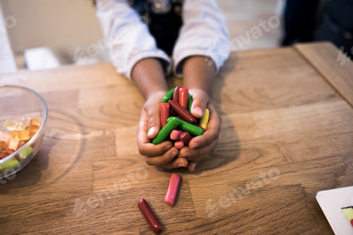 Preview: Hands of a little girl holding candies