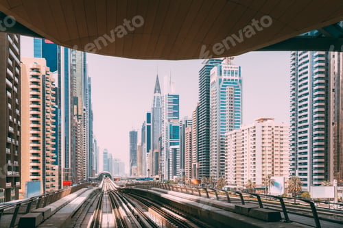 Preview: Modern Dubai Metro. Metro railway among glass skyscrapers in Dubai. Traffic on street in Dubai