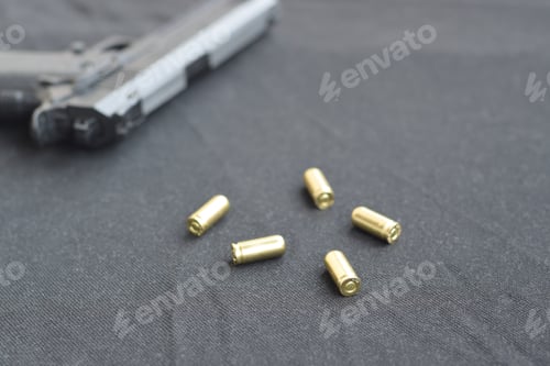 Preview: 9mm bullets and pistol lie on a black fabric