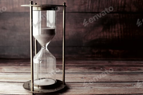 Preview: hourglass on table, sand flowing through the bulb of sandglass