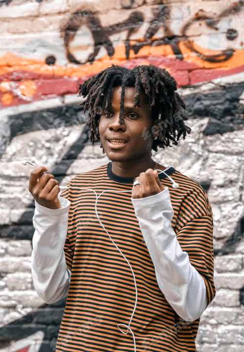 Preview: Portrait of young handsome dancing stylish black man with natural hair afro dreadlocks. Afroamerican