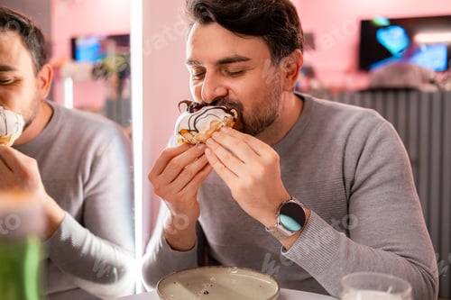 Preview: Man enjoys dessert in a modern cafe while reflecting on the taste and texture of food