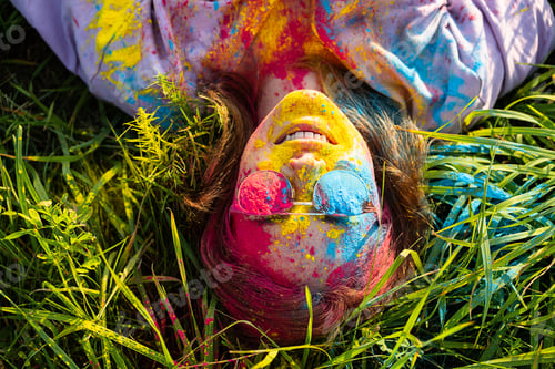 Preview: Woman covered holi powder in park. Holi colours festival.