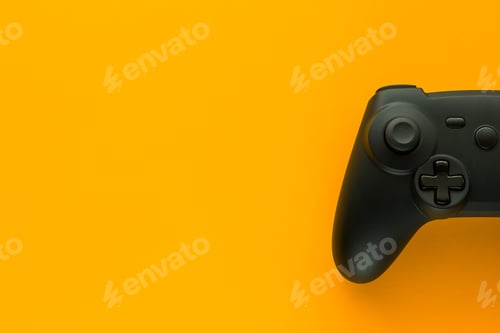 Preview: A gamepad on a yellow background and copy space in flat lay view
