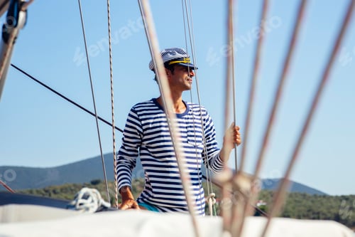 Preview: Handsome young man on a sailboat