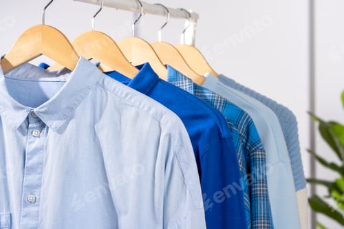 Preview: Shirts and Sweater Hanging in a Closet