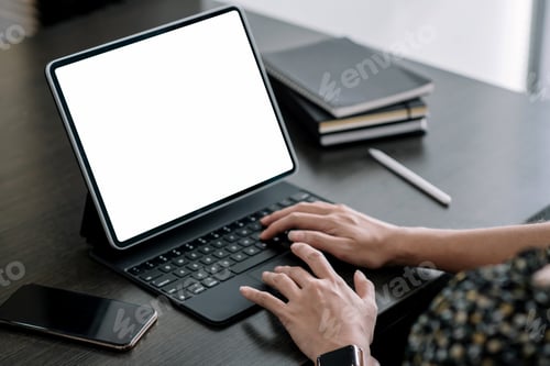 Preview: Close up. Woman hand typing on digital tablet keyboard with blank screen on desk at office.
