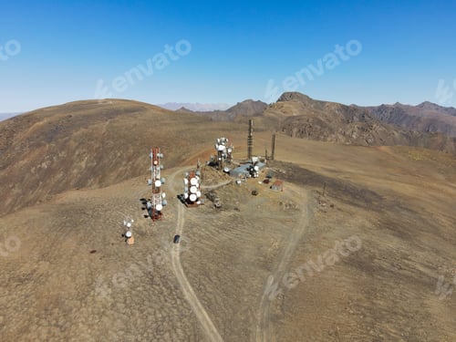 Preview: Communications towers on mountaintop with vehicle and tracks