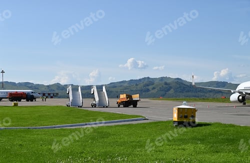 Preview: Ladder ladder at the rear entrance of a passenger aircraft,view of the tail and apron of the airport