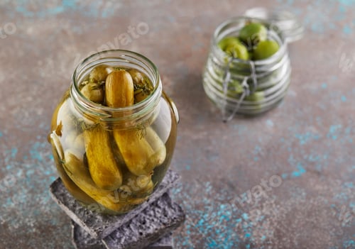 Preview: Fermented vegetarian canned food concept. Pickled cucumbers, olives in glass jars.