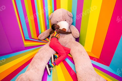 Preview: Beautiful young woman having fun inside a rainbow box room