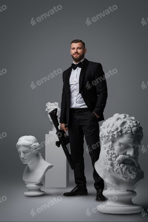 Preview: Stylish handsome man with beard wears a luxurious black suit and bowtie