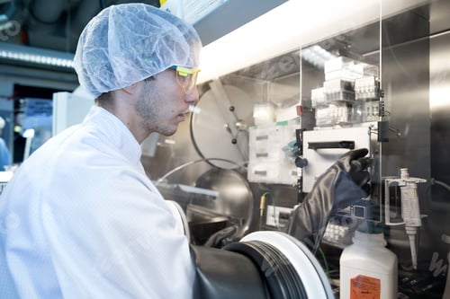 Preview: Male scientist adjusting switch in fume hood in lab cleanroom