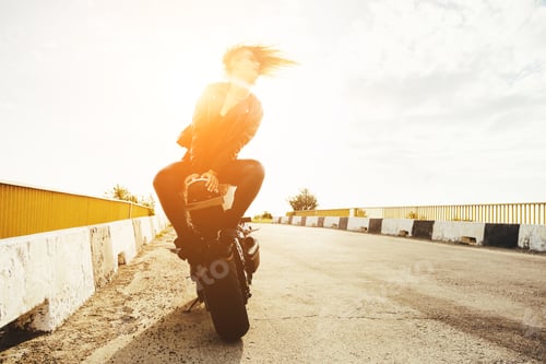 Preview: Biker girl in a leather clothes on a motorcycle