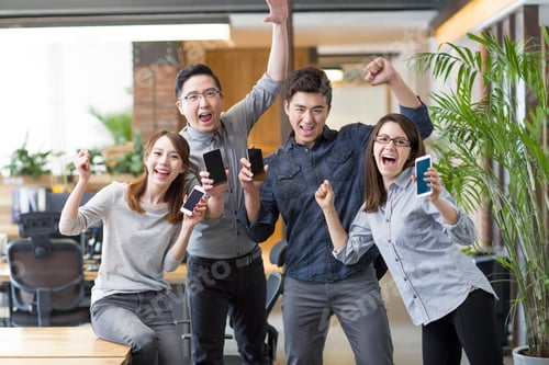 Preview: IT workers celebrating with smart phones in office