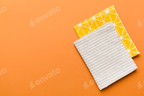 Preview: top view with gray kitchen napkin isolated on table background.