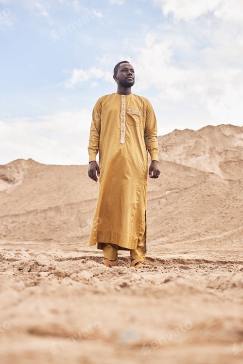 Preview: African American Man in Traditional Long Kaftan in Desert