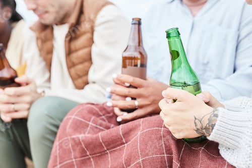 Preview: Young People Holding Beer Bottles Outdoors