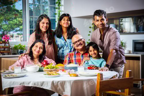 Preview: Happy Indian asian family having lunch at home and posing for photo