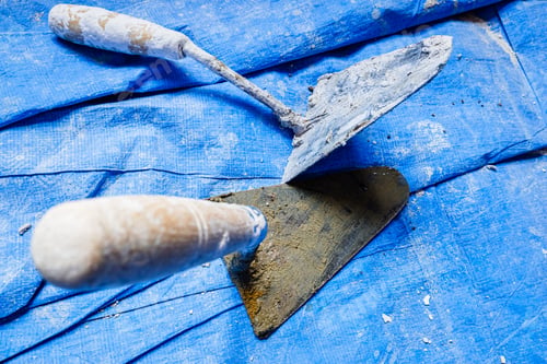 Preview: Dirty cement trowels used by bricklayers.