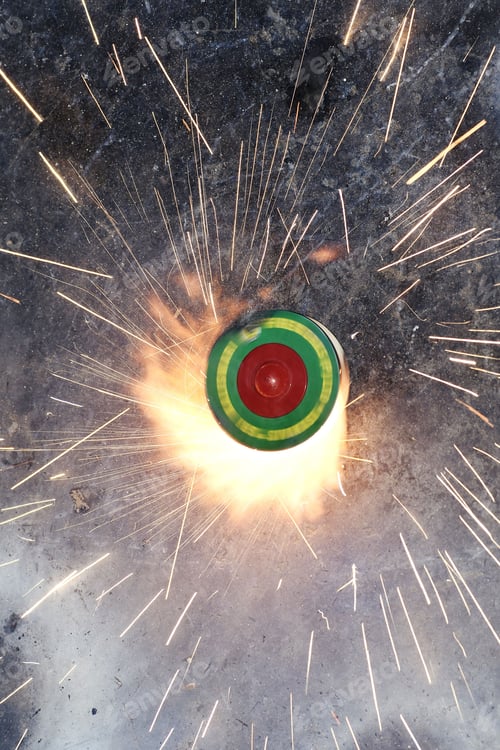 Preview: Vibrant firework emitting sparks on the rock