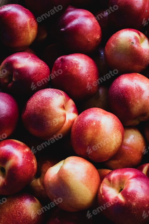 Preview: High angle close up of freshly picked yellow nectarines.