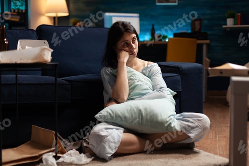 Preview: Portrait of depressed, vulnerable stressed desperate woman looking in camera sitting alone on couch