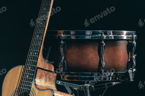 Preview: Acoustic guitar and snare drum on a black background isolated.
