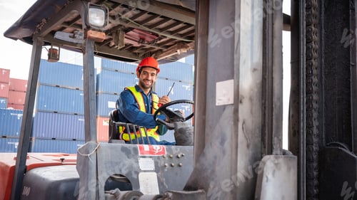 Preview: Engineer or foreman working and use talkie with a forklift in at container yard.