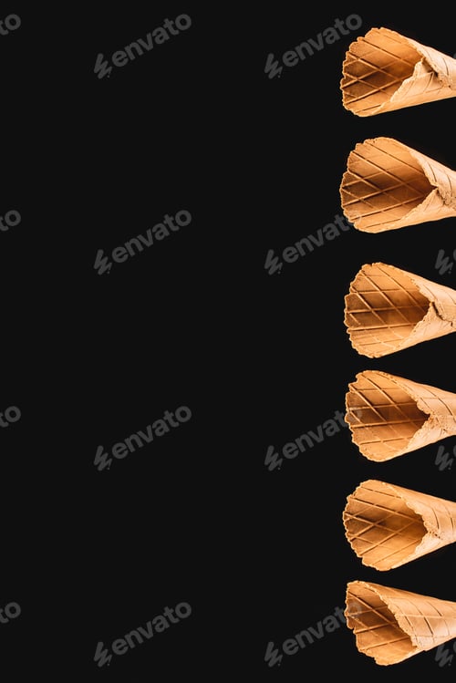 Preview: top view of row of ice cream cones isolated on black