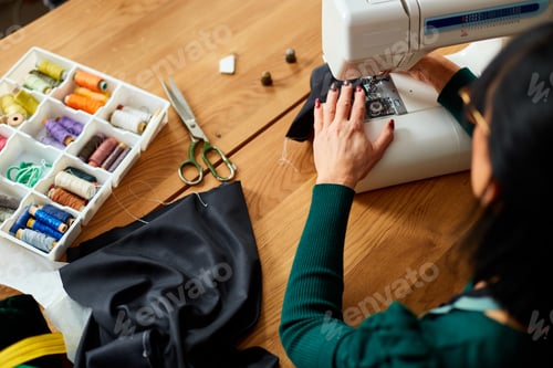 Preview: Step by step, 50-yers old woman sews clothes on sewing machine