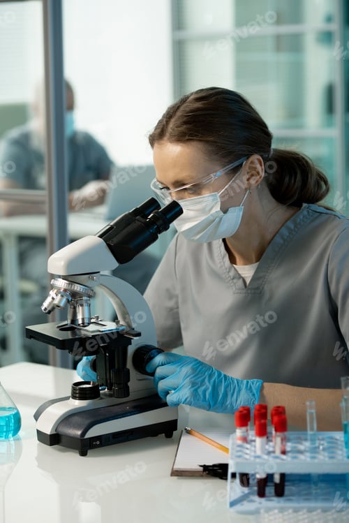 Preview: Virologist learning cells under microscope