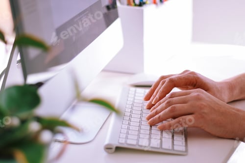Preview: Woman is sitting at a desk and working on a computer