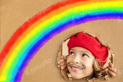 Preview: Happy child painting rainbow at home