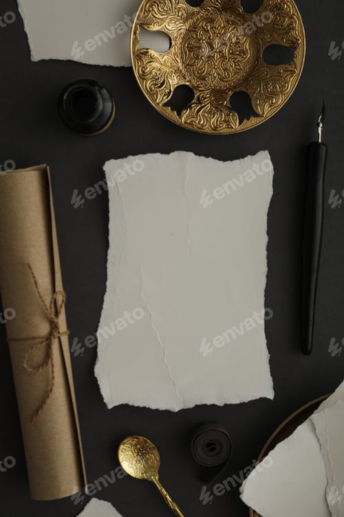 Preview: Papers, golden plates and spoon, ink bottle and pen on dark gray background, top view