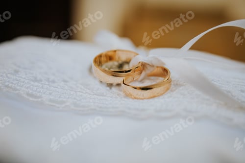 Preview: Selective focus shot of two golden wedding rings